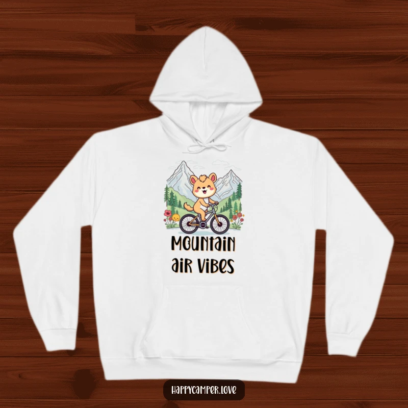 Funny hoodie featuring a happy animal cycling past a beautiful mountain vista, perfect for keeping warm after outdoor activities.